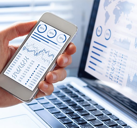 phone and computer showing business intelligence and analytics application